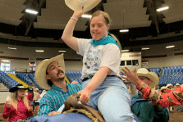 A girl on a saddle at the exceptional rodeo