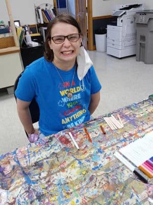 Christelle Cardwell working on an art project at a CHS activity center