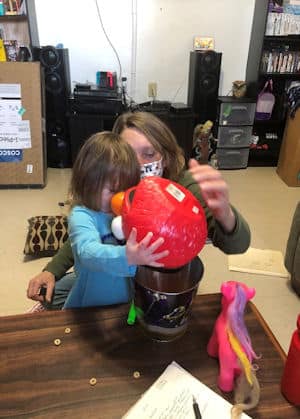 Diana pouring cheerios from one container to another