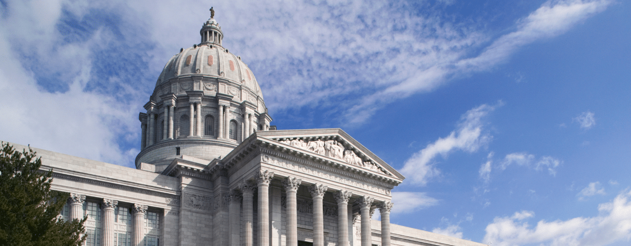 Missouri state capital sits in front of a blue cloudy sky.