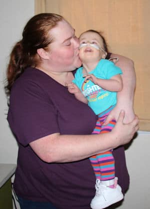 Two year old Lucille Beaman and her therapist.