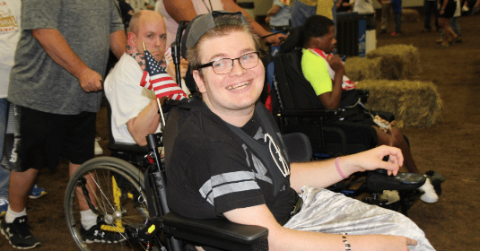 A young man in a wheel chair having fun at an event
