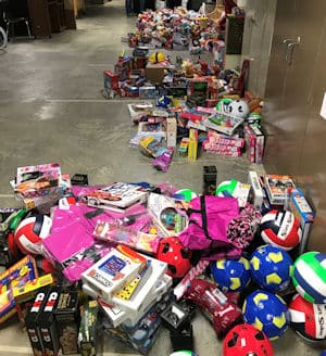 Piles of toys on the floor for Toys for Tots