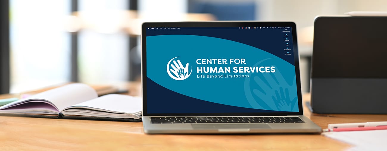 Center for Human brand materials on a laptop screen in a modern office