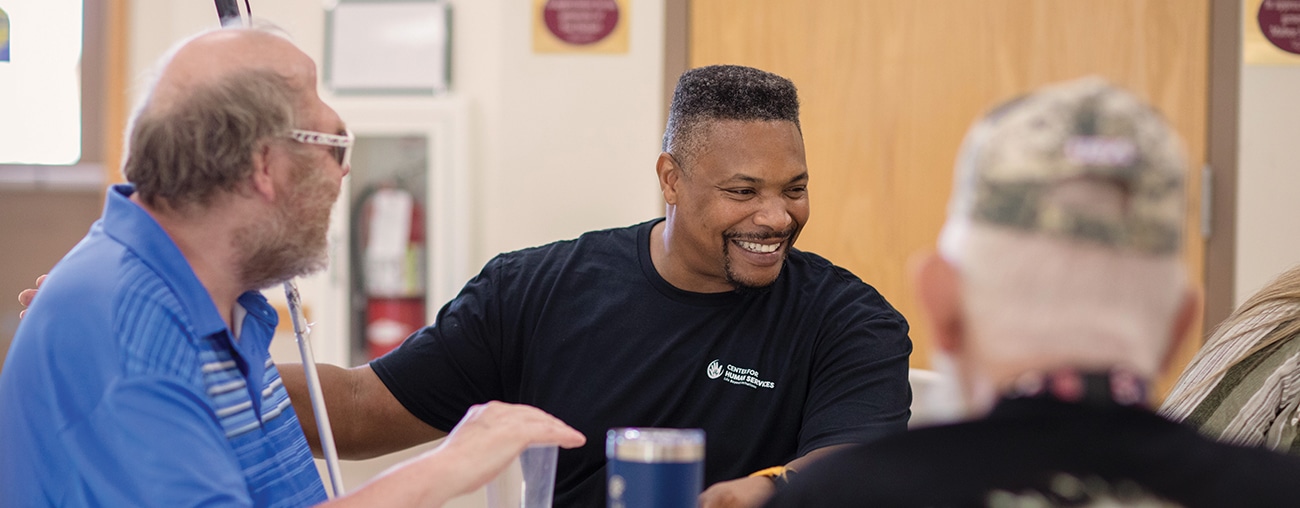 Smiling people talking around a table