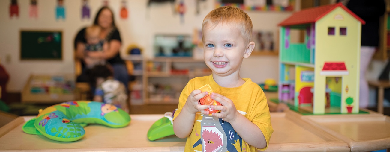 A young boy playing with a toy