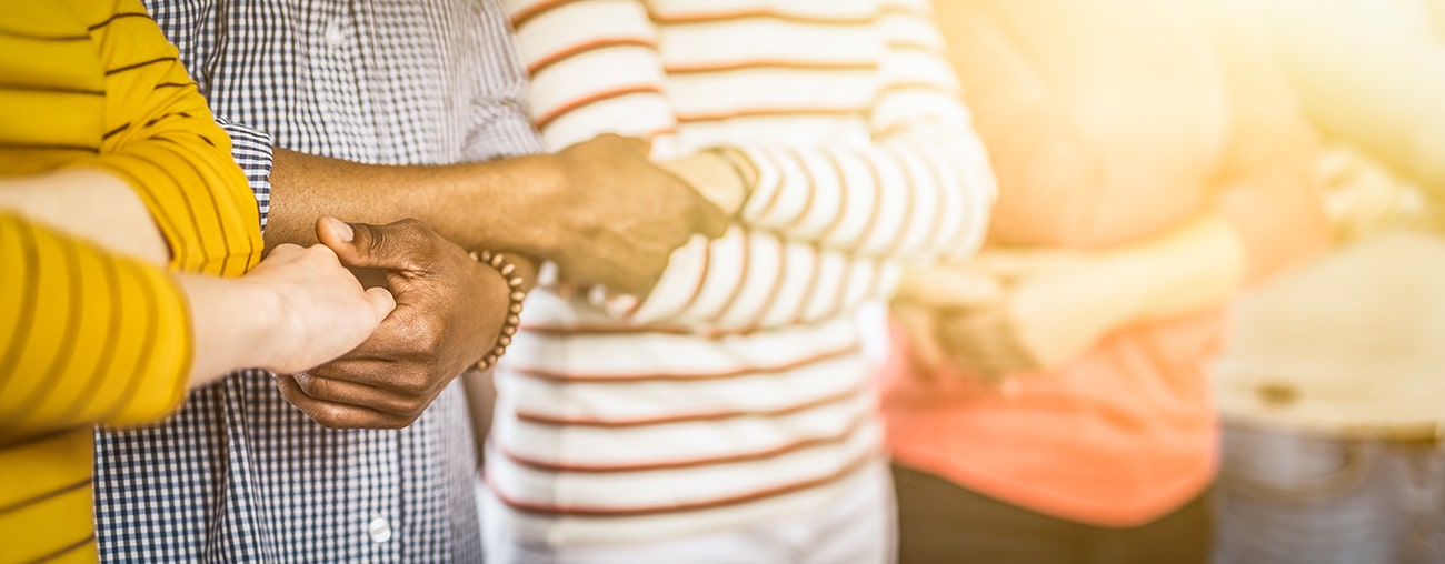 A line of people forming a partnership by shaking hands