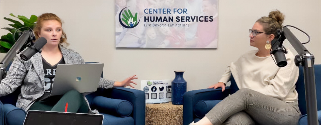 Two women talking in front of microphones on the Center for Human Services podcast