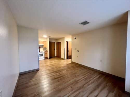 The living room and kitchen in a living space offered through affordable housing services